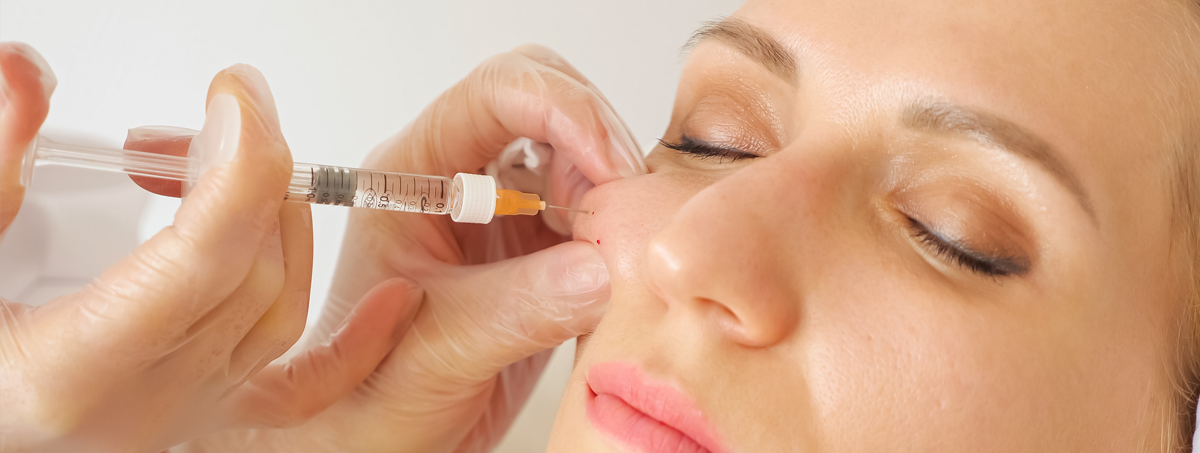 Woman having dermal filler injections